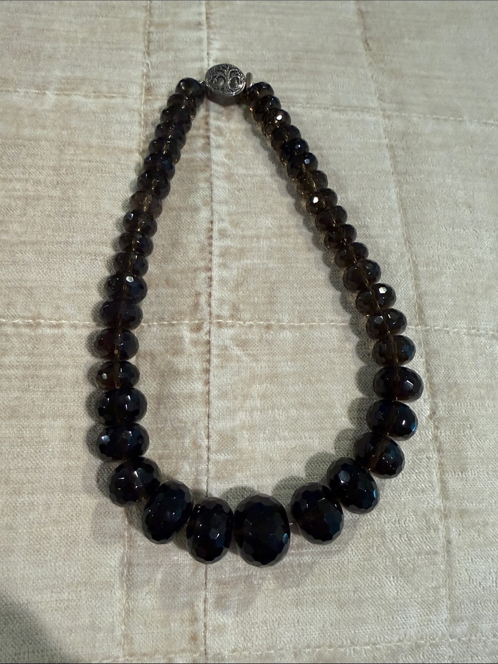 Smoky quartz necklace with sterling clasp.  Graduated size beads